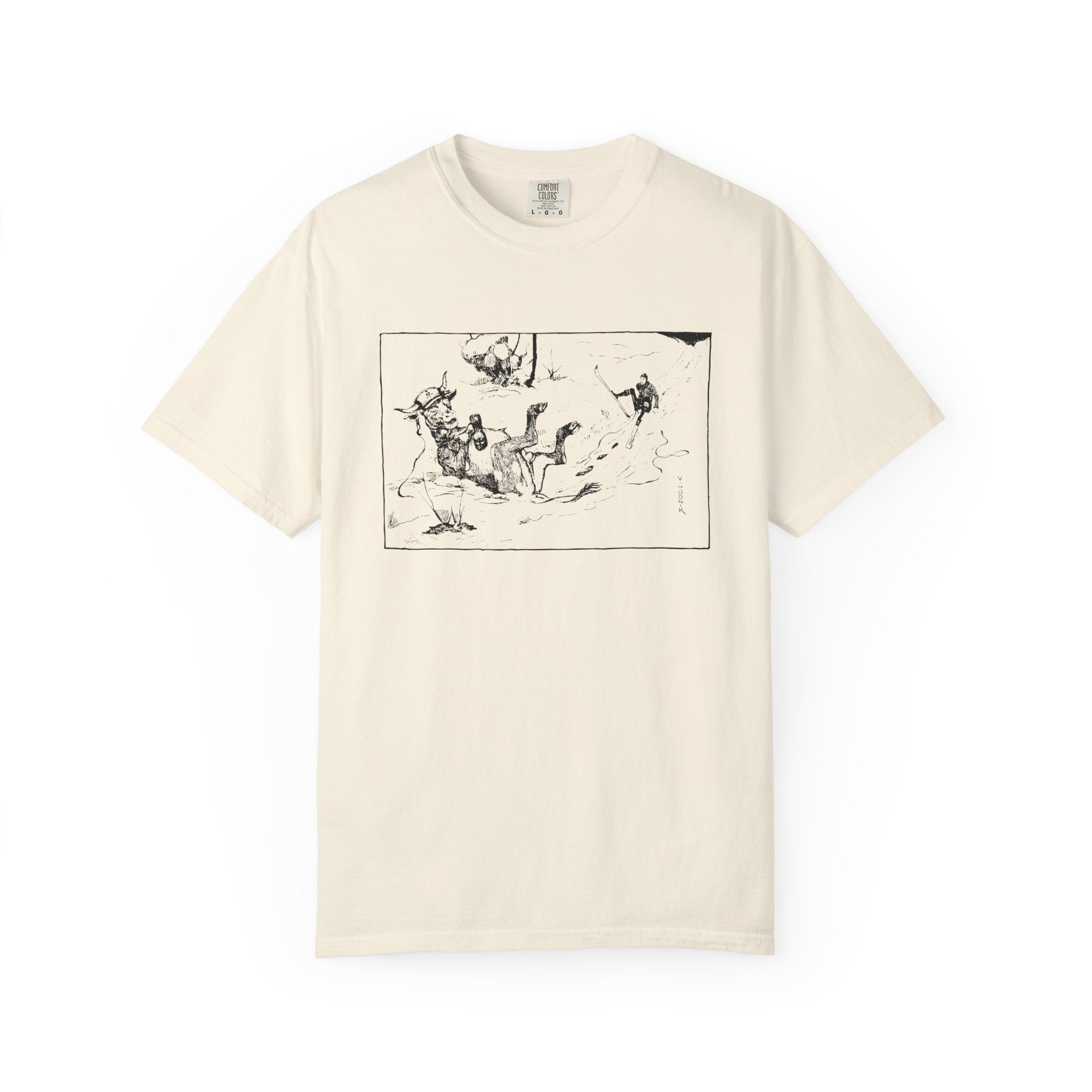 Beige T‑shirt featuring Valentin Hodnik’s artwork, showing a skier and a cow nearly colliding on a snowy slope.