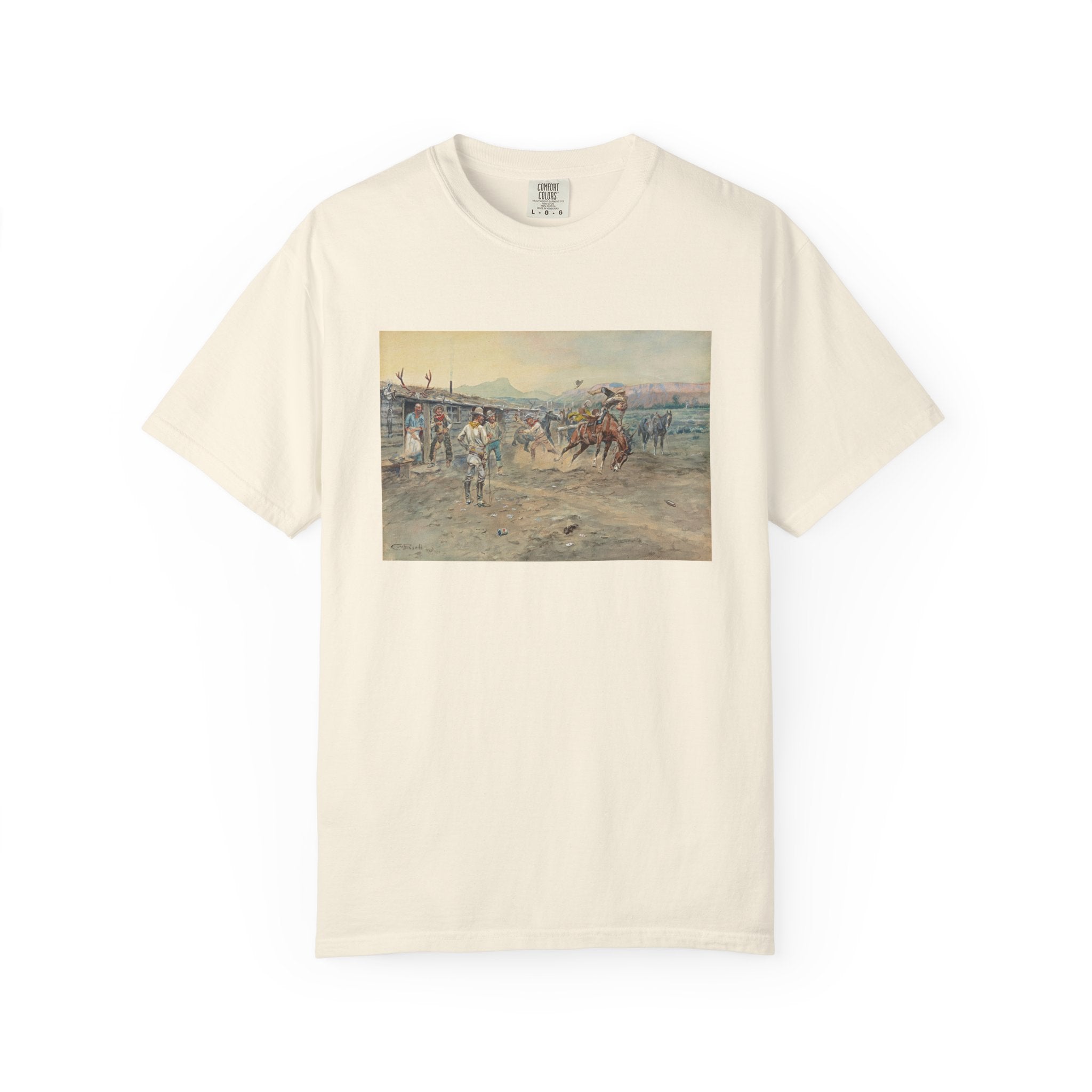Beige T‑shirt featuring Charles Marion Russell’s The Tenderfoot, showing a tenderfoot being thrown from a bucking horse while cowboys look on in a lively Western scene.