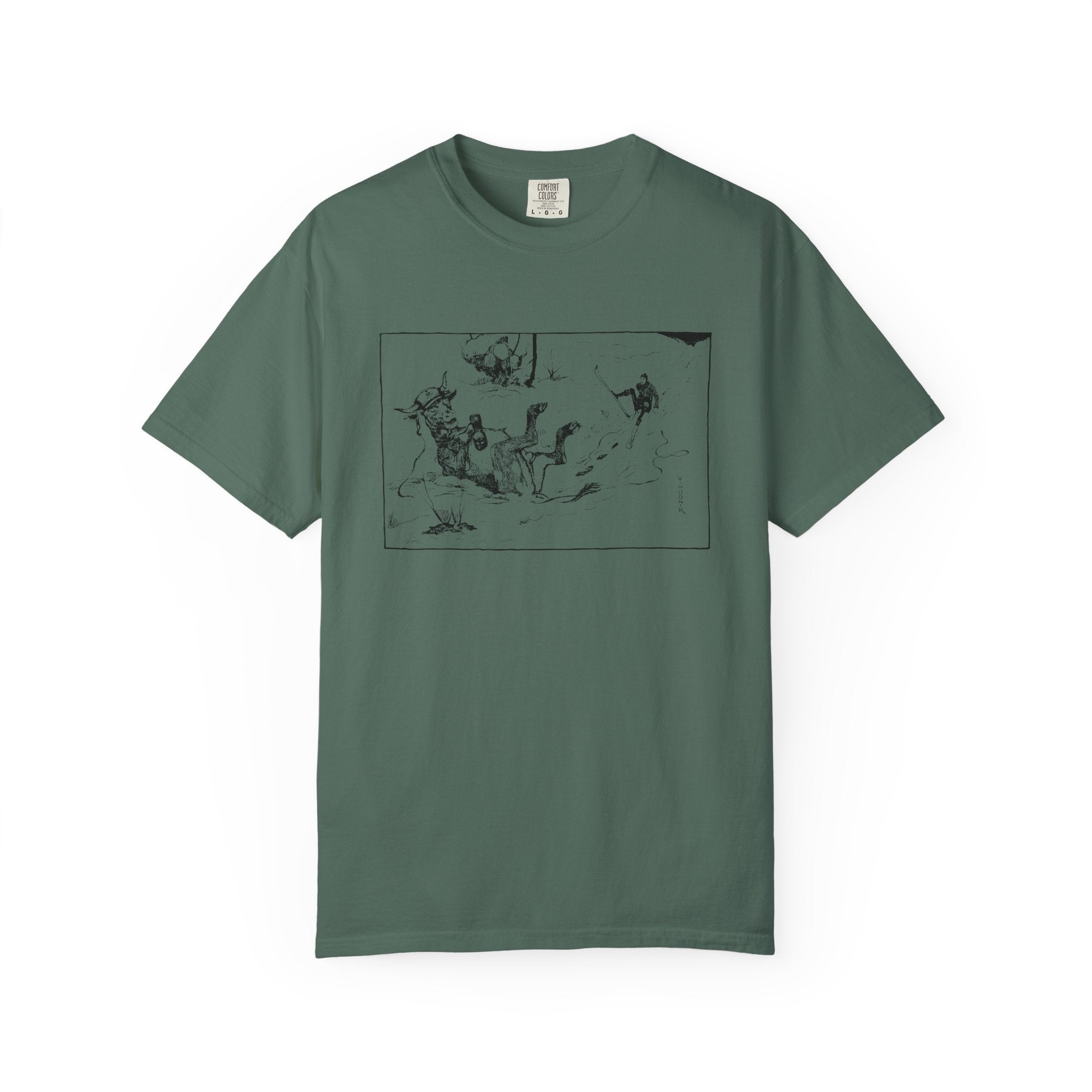 Green T‑shirt featuring Valentin Hodnik’s artwork, showing a skier and a cow nearly colliding on a snowy slope.