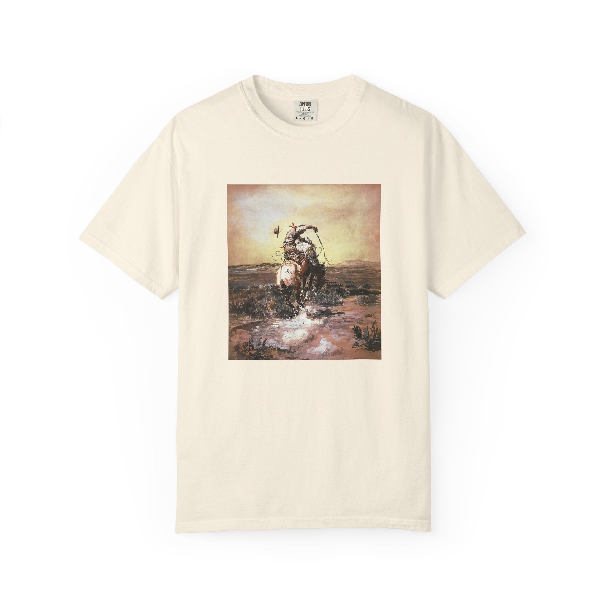 Beige T‑shirt featuring Charles Marion Russell’s A Slick Rider, showing a cowboy riding a bucking horse.
