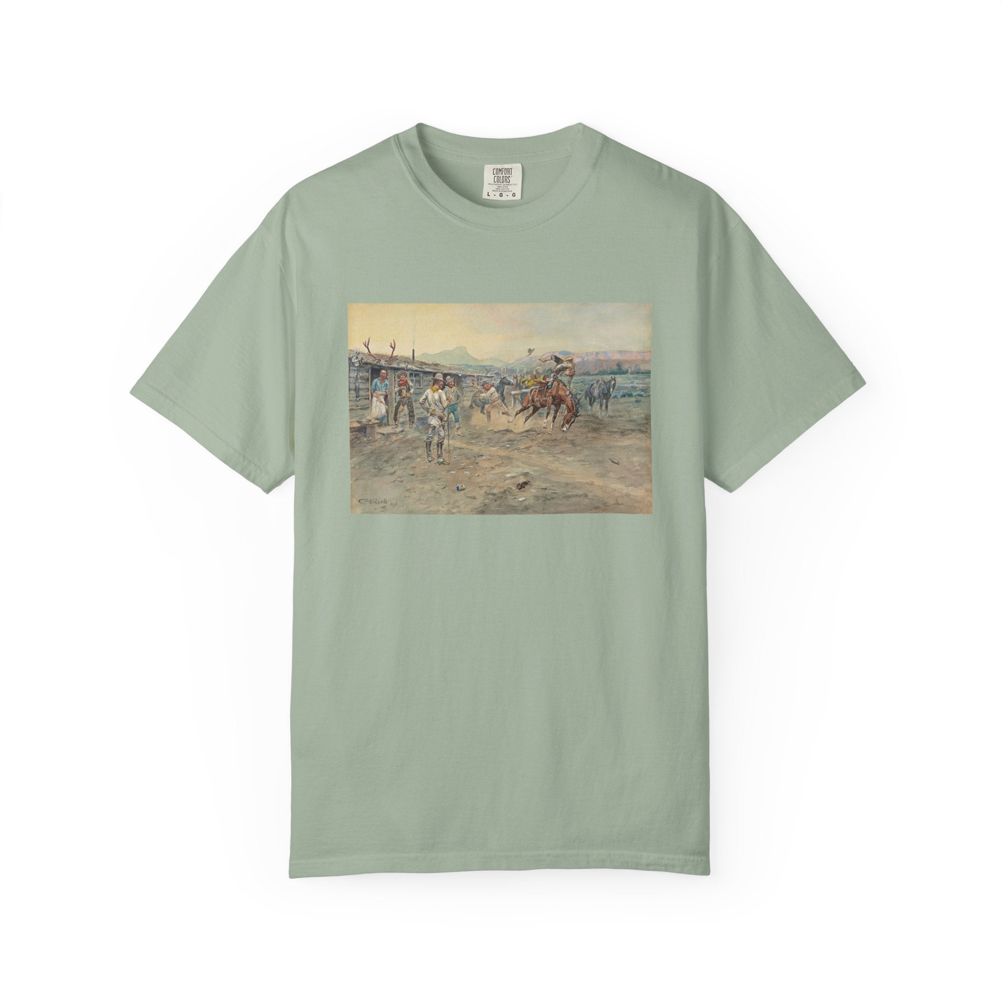 Green T‑shirt featuring Charles Marion Russell’s The Tenderfoot, showing a tenderfoot being thrown from a bucking horse while cowboys look on in a lively Western scene.
