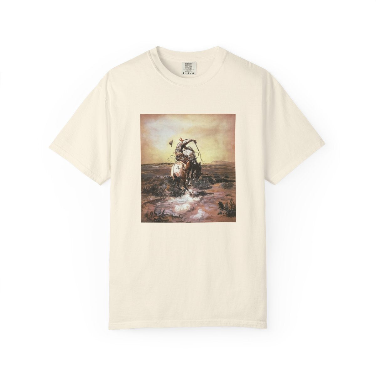 Beige T‑shirt featuring Charles Marion Russell’s A Slick Rider, showing a cowboy riding a bucking horse.